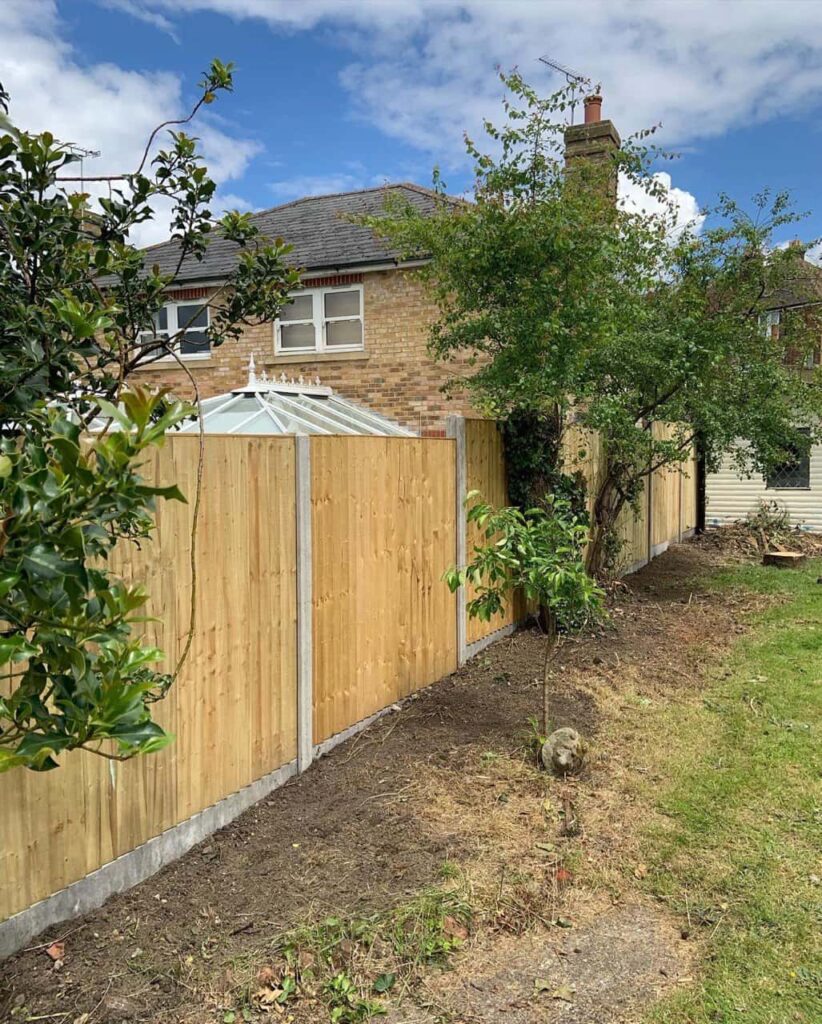 This is a photo of fence panels installed in a residential garden using concrete posts and gravel boards. Installed by Fast Fix Fencing Longstanton